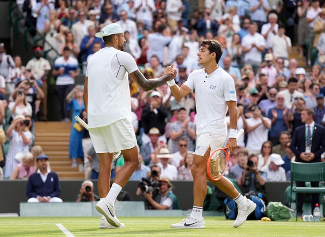Nick Kyrgios shakes hands with Cristian Garin