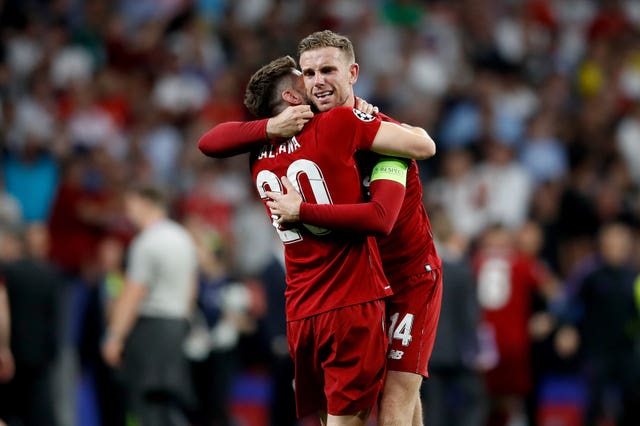 Adam Lallana celebrates with Liverpool captain Jordan Henderson