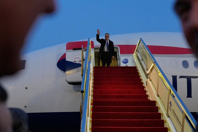 Prime Minister Sir Keir Starmer waves upon his arrival
