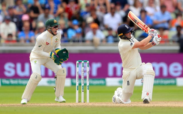 Chris Woakes, right, hits Nathan Lyon, not pictured, for six