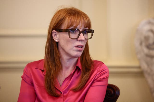 Angela Rayner seated, looking to her left, wearing a pink shirt