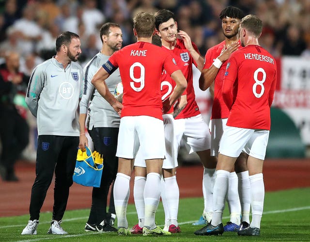 England players talk during a temporary stoppage against Bulgaria