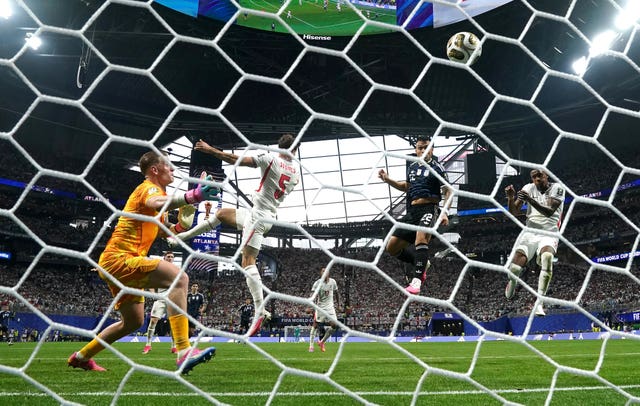 Lautaro Martinez, second right, gets between John Stones, centre left, and Ezri Konsa, right, to head Argentina’s winner against England