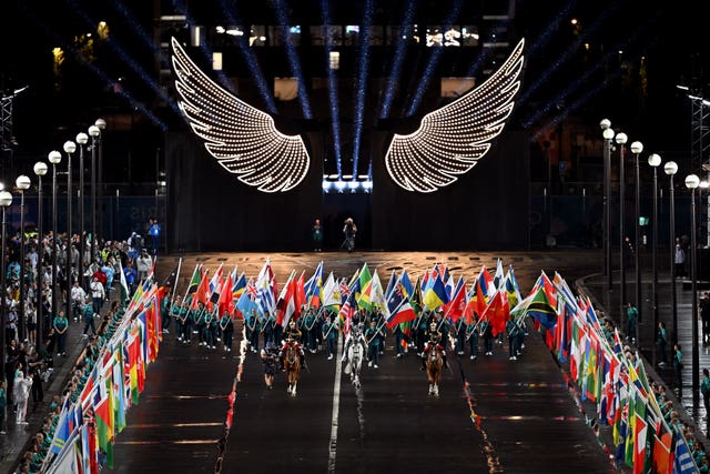 A horsewoman, wearing the flag of the International Olympic Committee, on a metal horse at the Trocadero