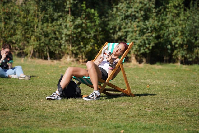 People enjoying the hot weather in Green Park, central London.