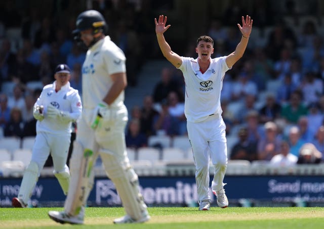 England’s Matt Fisher celebrates the dismissal of Devon Conway