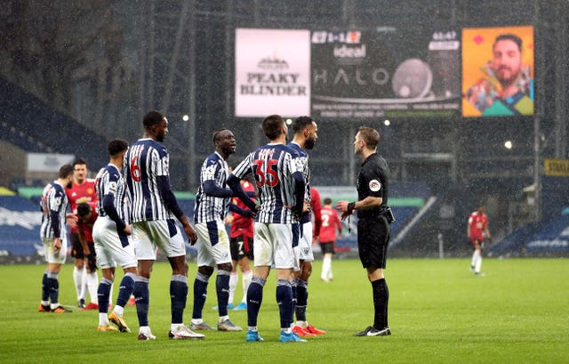 West Brom players complain to referee Craig Pawson about the penalty award before seeing it overturned