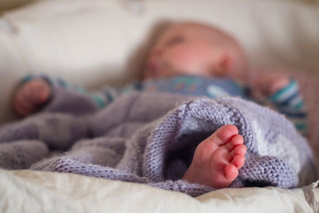 A baby sleeping in a basket