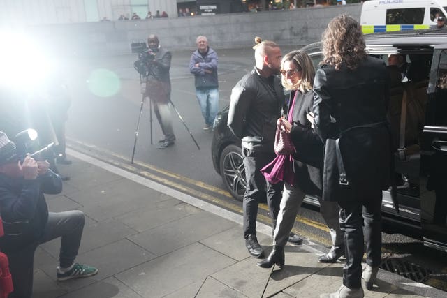 Russell Brand lit by the glare of flash photography