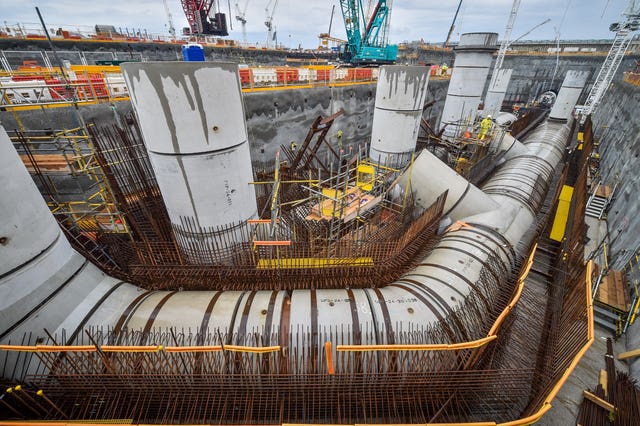 A worker inspects giant water cooling pipes during construction work at Hinkley Point C power station near Bridgwater, Somerset