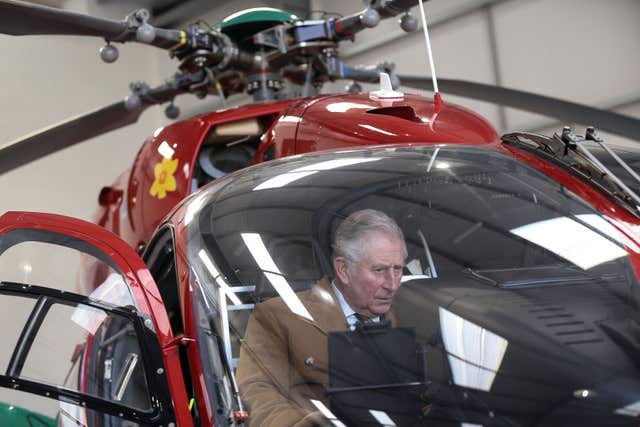 Charles examines the controls of an air ambulance (Aaron Chown/PA)