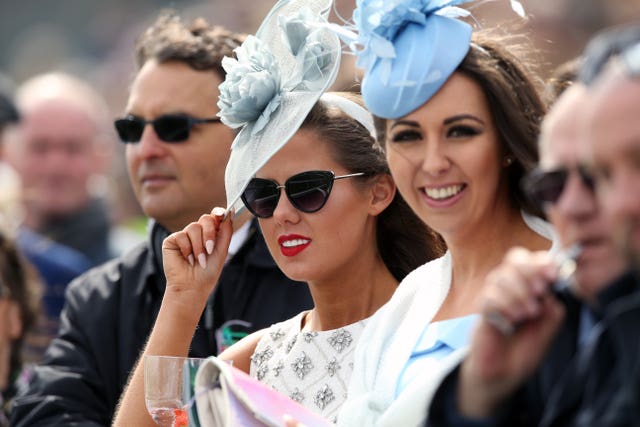 Racegoers watch the action during Ladies Day at Aintree