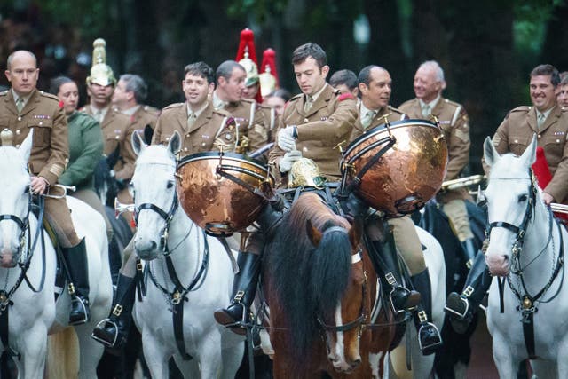 A member of the Household Cavalry checks his watch as service personnel from the Royal Navy, British Army, and Royal Air Force conduct a final early morning rehearsal through London ahead of Sunday’s Platinum Jubilee Pageant, which will mark the finale of the Platinum Jubilee Weekend