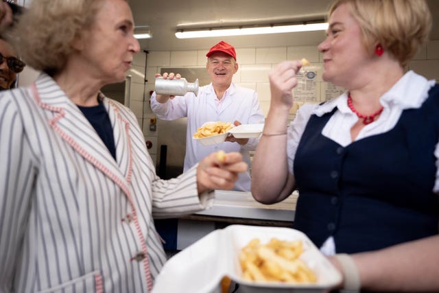 Sir Ed Davey serving up fish and chips at Brighton Palace Pier