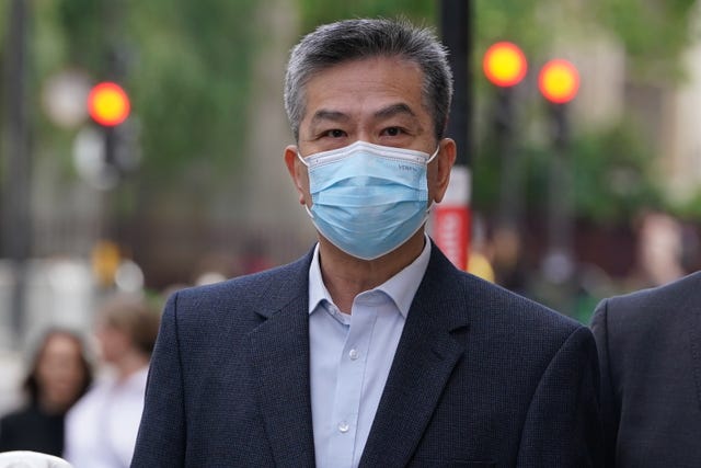 Head and shoulders photo of Bill Yuen outside court, wearing a blue facemask
