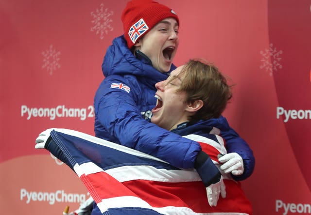 Great Britain’s Lizzy Yarnold (right) celebrates winning gold in the women’s skeleton with bronze medallist Laura Deas 