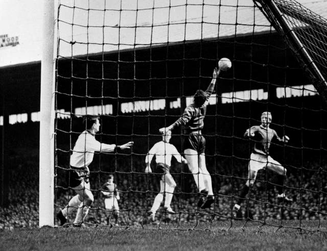 Manchester United's Denis Law (right) head the ball over Tommy Lawrence in a 3-0 win at Old Trafford in 1965