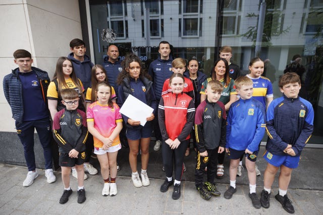 Representatives of South Antrim GAA, including young people from clubs across the county, hand in a letter to the Northern Ireland Secretary Hilary Benn at Erskine House in Belfast
