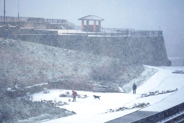 People walking in the snowy conditions in Cullercoats on North Tyneside