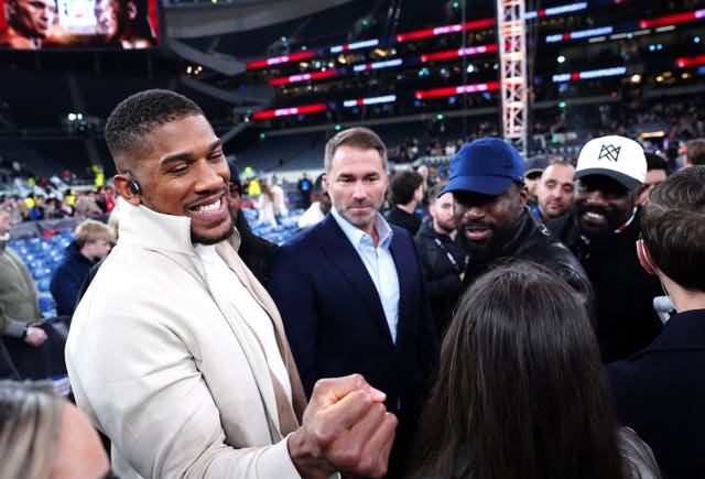 Anthony Joshua, left, and his promoter Eddie Hearn, centre, after Tyson Fury's fight with Arslanbek Makhmudov in April