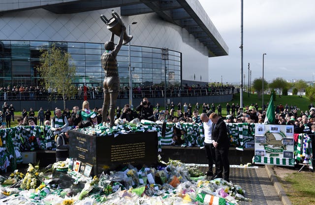 Celtic fans surround the Billy McNeill statue at Parkhead