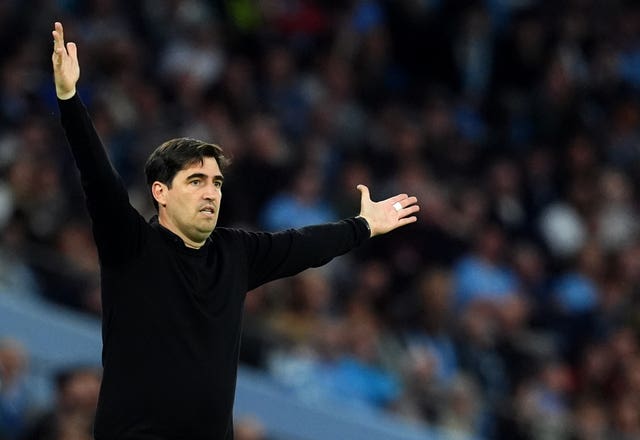 Bournemouth manager Andoni Iraola gestures with his arms spread wide during the loss to Manchester City