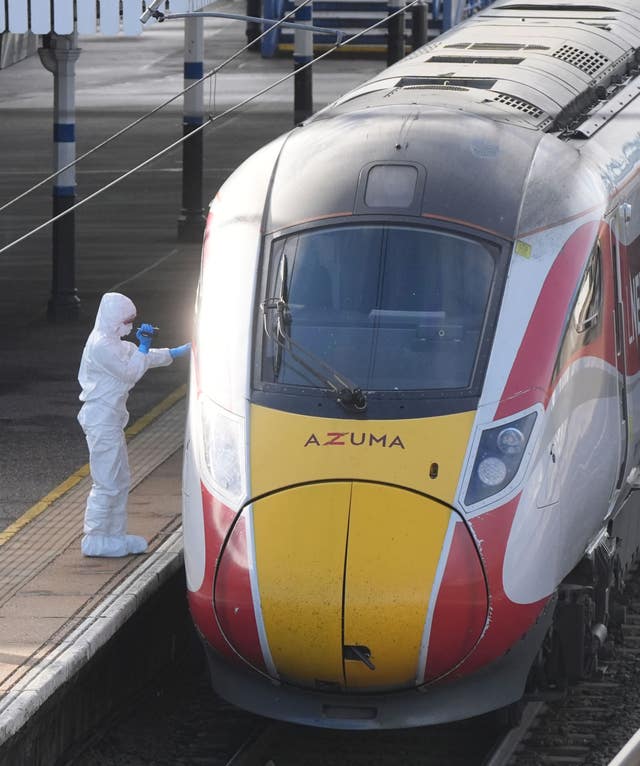 A forensic investigator on the platform by the train at Huntingdon station after the stabbing attack