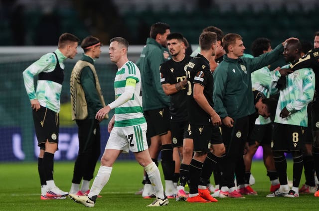 Celtic’s Callum McGregor leaves the pitch as Ferencvaros celebrate