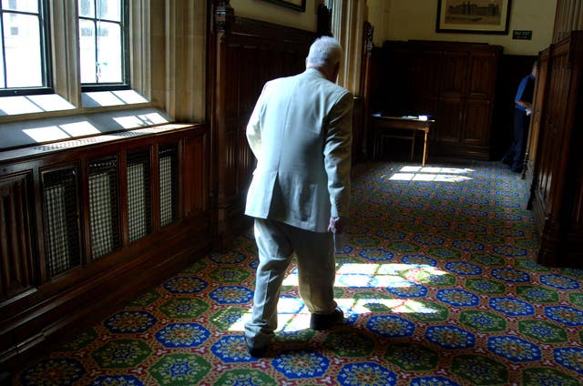 Press Association political correspondent Chris Moncrieff returns to the press gallery after talking to trainee journalists about his career, in the Houses of Parliament in Westminster, London