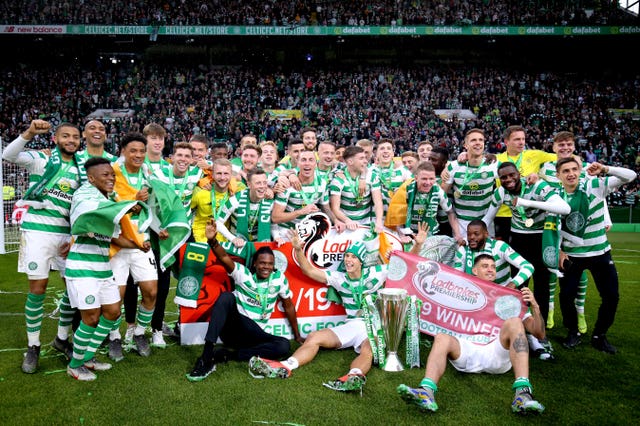 Celtic players celebrate with the trophy