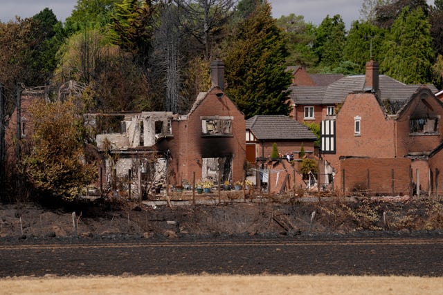 Housing Secretary Angela Rayner views the burnt-out remains of houses on Quarry Park Road in Stourbridge, West Midlands, following a huge blaze that destroyed 19 homes