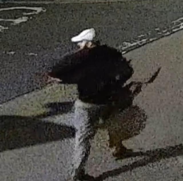 CCTV image of four people walking down a street