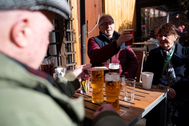 Customers enjoy a drink at the reopening of the Figure of Eight pub in Birmingham