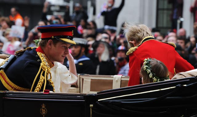 Prince Harry rides in an Ascot Landau, with a pageboy and bridesmaids, in the carriage procession that followed the Duke and Duchess of Cambridge's 2011 wedding. Jasper Juinen/PA Wire