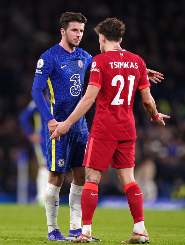 Mason Mount, left, and Kostas Tsimikas clash during the first half