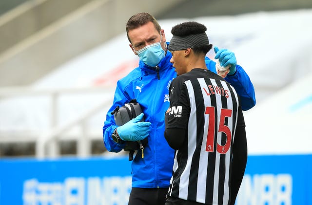 Newcastle's Jamal Lewis received treatment for a head injury against Brighton