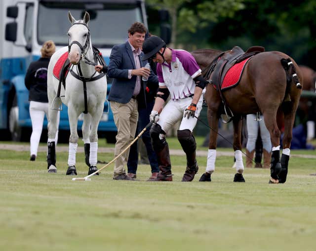 William shares a joke as he hops off his horse (Steve Parsons/PA)