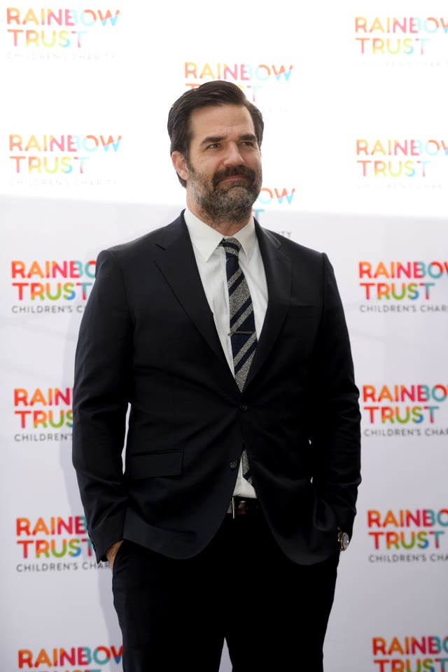 Rob Delaney in a black suit