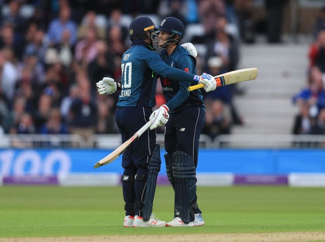 Roy celebrates his century with Joe Root (right)