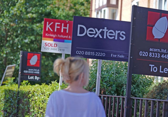 Estate agent signs outside apartments in Lewisham, south-east London