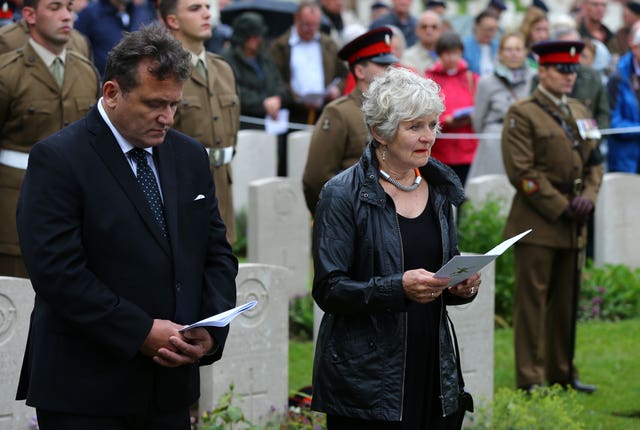 Margot Bains, niece of Private Henry Wallington, one of two young privates and an unknown soldier, who fought during the First World War, reads a poem during a burial service at Hermies Hill British Cemetery, near Albert, France