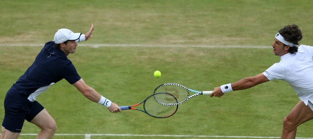 Andy Murray, left, and Feliciano Lopez both go for a volley at the net