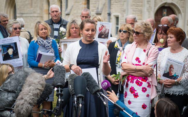 Bridget Reeves (centre), the granddaugher of Elsie Devine who died at Gosport War Memorial Hospital, and her mother Ann (second from right) speak to the media after the disclosure of the Gosport Independent Panel's report