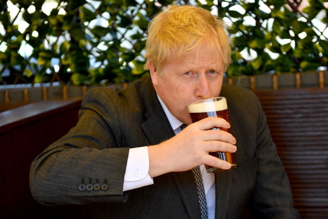 Prime Minister Boris Johnson enjoys a pint in the beer garden during a visit to The Mount pub and restaurant in Wolverhampton