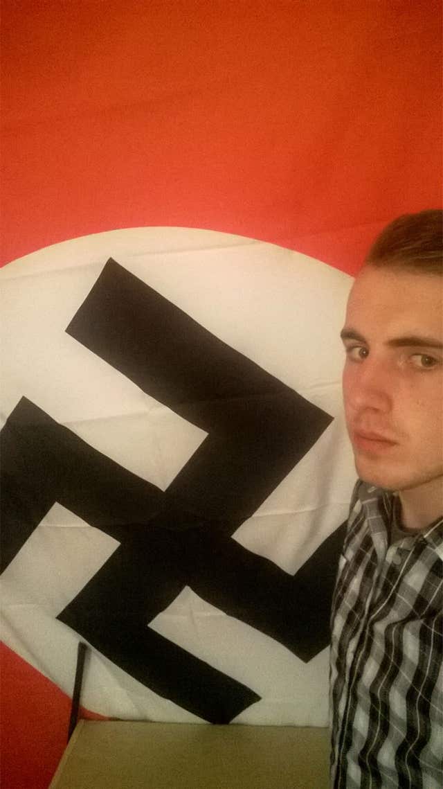 Ethan Stables posing next to a Nazi flag at his flat in Barrow (Greater Manchester Police/PA)