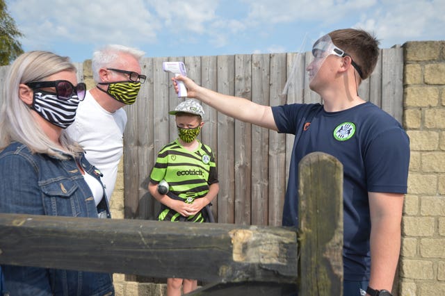 A fan gets his temperature tested ahead of a game at Forest Green