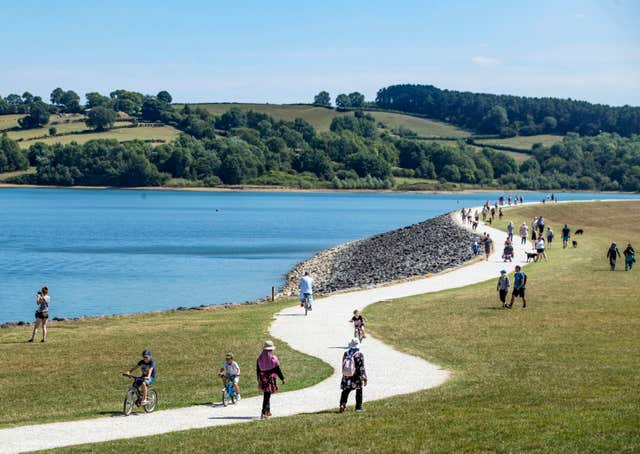 People walking in the sunshine at Carsington Water in Derbyshire