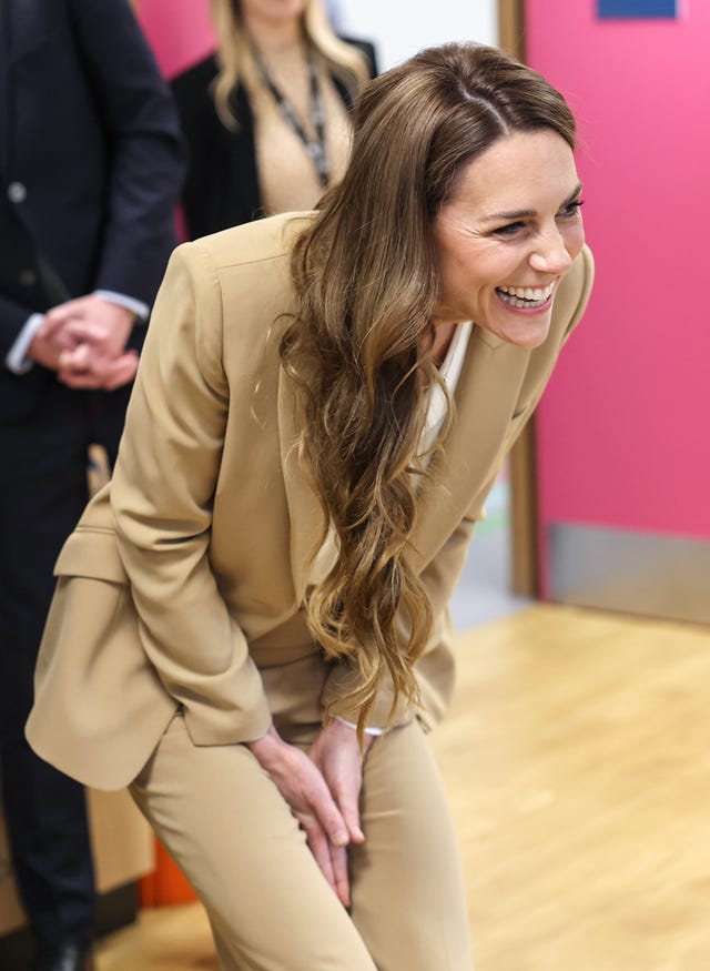 Kate smiling as she greets youngsters during the official visit