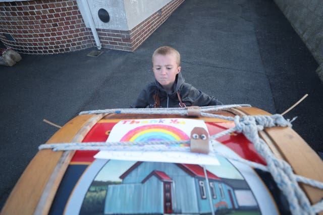 Adam Black, 10, from Markethill in Co Armagh, Northern Ireland, plays a Lambeg drum to salute local heroes during Thursday’s nationwide Clap for Carers initiative