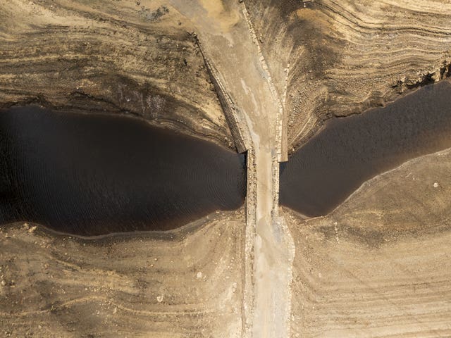 Aerial view of dry, cracked earth and low water levels on a reservoir